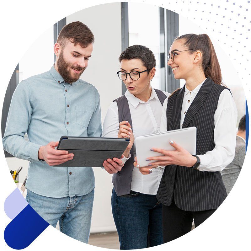 Three colleagues reviewing software on tablets